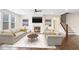Well decorated living room including a fire place and staircase at 5195 Belmore Manor Ct, Suwanee, GA 30024