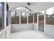Enclosed sunroom with many windows provides peaceful views of surrounding trees and backyard at 5195 Belmore Manor Ct, Suwanee, GA 30024