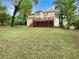Large backyard featuring a wood deck and a lush lawn at 9979 Bridgewater Pointe, Villa Rica, GA 30180