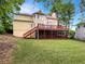 Backyard with a large deck, screened porch, and a grassy lawn surrounded by trees at 9979 Bridgewater Pointe, Villa Rica, GA 30180
