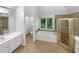 Bathroom with a jacuzzi tub, glass shower, and double vanity at 9979 Bridgewater Pointe, Villa Rica, GA 30180