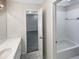 Bright bathroom featuring a tiled shower and a neutral color scheme at 9979 Bridgewater Pointe, Villa Rica, GA 30180