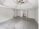 A spacious main bedroom with carpet, tray ceilings, and neutral-colored walls at 9979 Bridgewater Pointe, Villa Rica, GA 30180