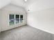 Comfortable bedroom with a vaulted ceiling, large window and plush carpet at 9979 Bridgewater Pointe, Villa Rica, GA 30180
