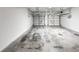 Spacious three car garage featuring concrete floors and two overhead doors at 9979 Bridgewater Pointe, Villa Rica, GA 30180