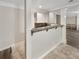 A kitchen showcasing tiled flooring, white cabinets, and a beautiful tile backsplash at 9979 Bridgewater Pointe, Villa Rica, GA 30180