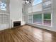 Bright living room with vaulted ceilings, large windows, fireplace, and hardwood floors at 9979 Bridgewater Pointe, Villa Rica, GA 30180