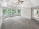 Main bedroom featuring a tray ceiling, lots of natural light, and ensuite bathroom at 9979 Bridgewater Pointe, Villa Rica, GA 30180