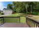 From the backyard deck, admire the lush green lawn, bordered by a wooden fence and trees. Two-car garage visible at 136 Walkers Pond Dr, Villa Rica, GA 30180
