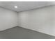 A clean basement room featuring concrete walls and neutral flooring, perfect for storage or finishing to your liking at 136 Walkers Pond Dr, Villa Rica, GA 30180