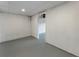Basement room with concrete walls, neutral flooring, and an open doorway leading to another room at 136 Walkers Pond Dr, Villa Rica, GA 30180