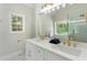 Bright bathroom with white cabinets, double sink and a large mirror at 136 Walkers Pond Dr, Villa Rica, GA 30180
