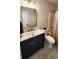 Modern bathroom featuring a blue vanity, gold hardware, and patterned tile flooring at 136 Walkers Pond Dr, Villa Rica, GA 30180
