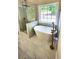 Luxury bathroom with freestanding tub, glass shower, and a large window at 136 Walkers Pond Dr, Villa Rica, GA 30180