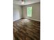 Bedroom features hardwood floors, neutral walls, and a window with a view at 136 Walkers Pond Dr, Villa Rica, GA 30180