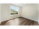 Well-lit bedroom with hardwood floors and a window overlooking a green backyard at 136 Walkers Pond Dr, Villa Rica, GA 30180