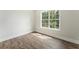 Sunlit bedroom with hardwood floors, a large window, and neutral wall paint at 136 Walkers Pond Dr, Villa Rica, GA 30180