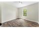 Bedroom featuring light-colored walls, hardwood floors, and a window at 136 Walkers Pond Dr, Villa Rica, GA 30180