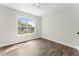 Bright bedroom with hardwood floors and a large window offering scenic outdoor views at 136 Walkers Pond Dr, Villa Rica, GA 30180
