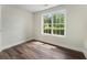 Bright bedroom with hardwood floors and a window offering backyard views at 136 Walkers Pond Dr, Villa Rica, GA 30180