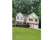 Charming two-story home with brick accents, a well-manicured lawn, and a welcoming front entrance at 136 Walkers Pond Dr, Villa Rica, GA 30180