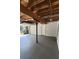 Spacious garage with exposed ceiling beams and concrete floors at 136 Walkers Pond Dr, Villa Rica, GA 30180