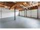 Spacious garage features two overhead doors, exposed ceiling, gray floor and ample room for vehicles and storage at 136 Walkers Pond Dr, Villa Rica, GA 30180