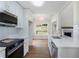 Eat-in kitchen with white cabinets, stainless steel appliances, a breakfast nook and hardwood floors at 136 Walkers Pond Dr, Villa Rica, GA 30180