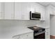 Close up on a contemporary kitchen featuring white cabinets, quartz countertops, and stainless steel appliances at 136 Walkers Pond Dr, Villa Rica, GA 30180