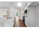 Stylish updated kitchen with white cabinets, stainless steel appliances, quartz countertops, and hardwood floors at 136 Walkers Pond Dr, Villa Rica, GA 30180