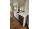 Kitchen island with stainless steel appliances, white cabinets, and stone countertops at 136 Walkers Pond Dr, Villa Rica, GA 30180
