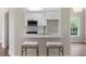 Bright eat-in kitchen features white cabinets, stainless steel appliances, and breakfast bar with comfortable seating at 136 Walkers Pond Dr, Villa Rica, GA 30180