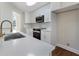 Bright kitchen featuring white cabinets, stainless steel appliances, modern fixtures, and hardwood floors at 136 Walkers Pond Dr, Villa Rica, GA 30180