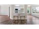 Modern kitchen area with a breakfast bar, white cabinets, and stainless steel appliances at 136 Walkers Pond Dr, Villa Rica, GA 30180