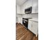 Modern kitchen with white cabinetry, stainless steel appliances, and subway tile backsplash at 136 Walkers Pond Dr, Villa Rica, GA 30180