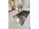 Kitchen stainless steel sink features a modern faucet and white countertops at 136 Walkers Pond Dr, Villa Rica, GA 30180