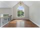 Elegant living room with hardwood floors, high ceilings, lots of natural light, and elegant light fixture at 136 Walkers Pond Dr, Villa Rica, GA 30180