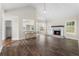 Open-concept living room with a cozy fireplace, vaulted ceilings, and hardwood floors at 136 Walkers Pond Dr, Villa Rica, GA 30180
