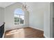 Open living room with hardwood floors, high ceilings, lots of natural light, and elegant light fixture at 136 Walkers Pond Dr, Villa Rica, GA 30180