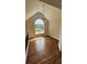 Bright living room features hardwood floors, arched window, and modern chandelier at 136 Walkers Pond Dr, Villa Rica, GA 30180