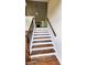 Elegant staircase with hardwood steps, white risers, and a contrasting dark railing at 136 Walkers Pond Dr, Villa Rica, GA 30180