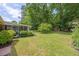 Well-maintained backyard featuring green lawn, mature trees, and screened porch perfect for outdoor entertaining at 1732 Samaria Trl, Tucker, GA 30084