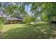 Serene backyard view showcases lush grass and mature trees, offering a private and peaceful retreat at 1732 Samaria Trl, Tucker, GA 30084