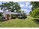 The expansive backyard shows a well-maintained lawn, mature trees and a screened-in porch at 1732 Samaria Trl, Tucker, GA 30084