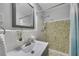 Cozy bathroom features decorative tile accent in shower, updated fixtures, and framed mirror at 1732 Samaria Trl, Tucker, GA 30084