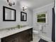Bathroom features a double vanity with modern lighting and fixtures, with a window providing natural light at 1732 Samaria Trl, Tucker, GA 30084