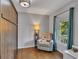 Cozy bedroom with hardwood floors, a large window, and a comfortable seating area at 1732 Samaria Trl, Tucker, GA 30084