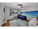 This bedroom features a ceiling fan and natural light, with a creative mural at 1732 Samaria Trl, Tucker, GA 30084