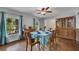 Formal dining room with hardwood floors, a ceiling fan, and natural light from the large windows at 1732 Samaria Trl, Tucker, GA 30084