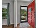 Bright entryway with a red front door and hardwood flooring at 1732 Samaria Trl, Tucker, GA 30084